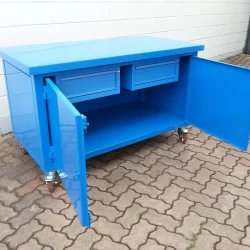 work-bench with wheels and drawers inside a two-door cabinet